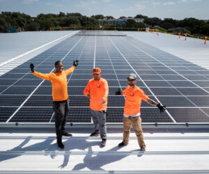 Men celebrating installation of Solar Panels