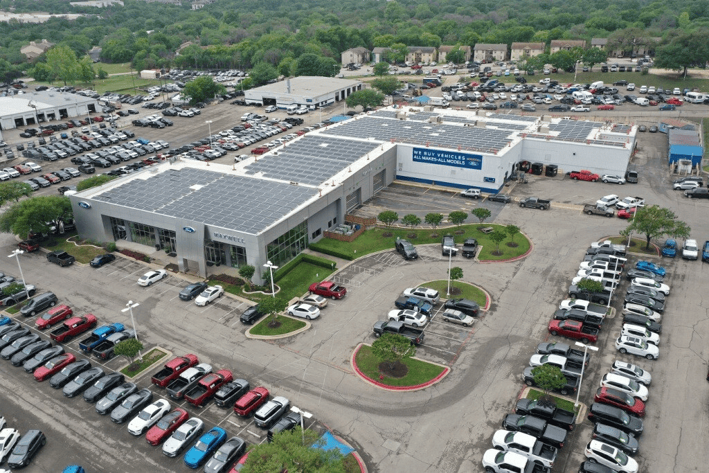 aerial view of a building surrounded by cars