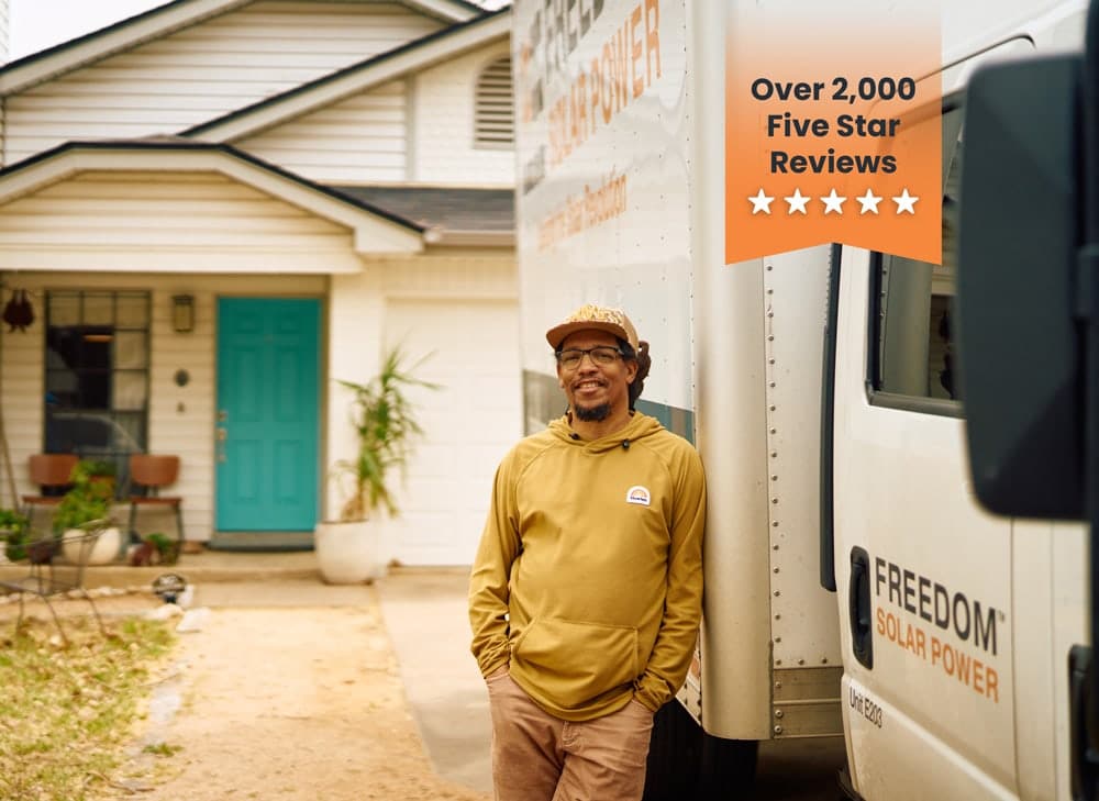 Man standing against a Freedom solar truck