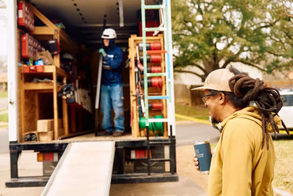 Installer Unloading Solar Panel from Truck