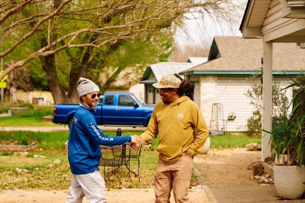 Freedom Solar Installer and Alvin Dedeaux Shaking Hands